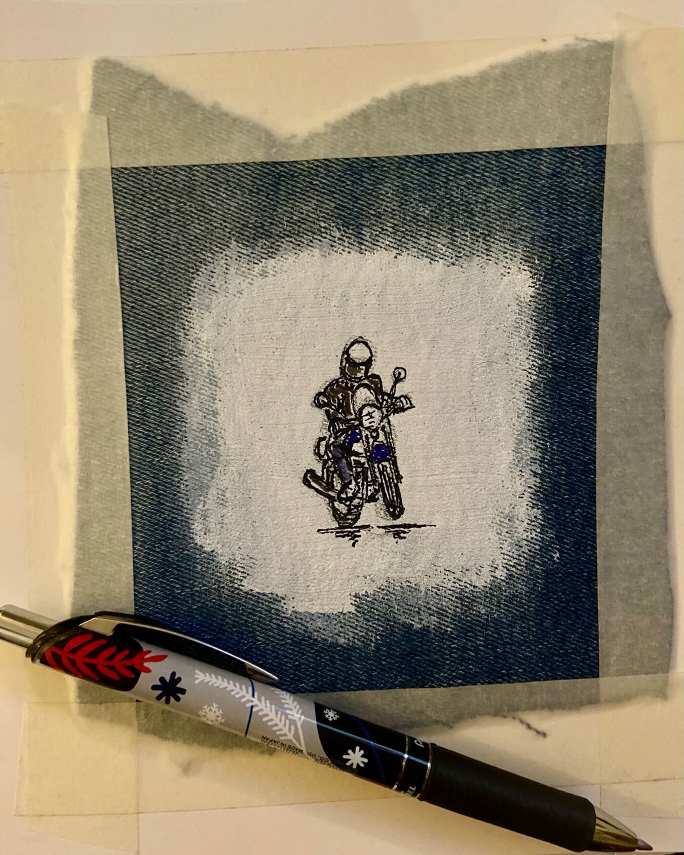 A motorcyclist drawn on fabric